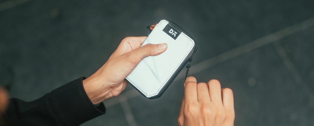 Wallet made from lightweight reflective fabric with card slots, cash compartment, and external pocket for quick access.