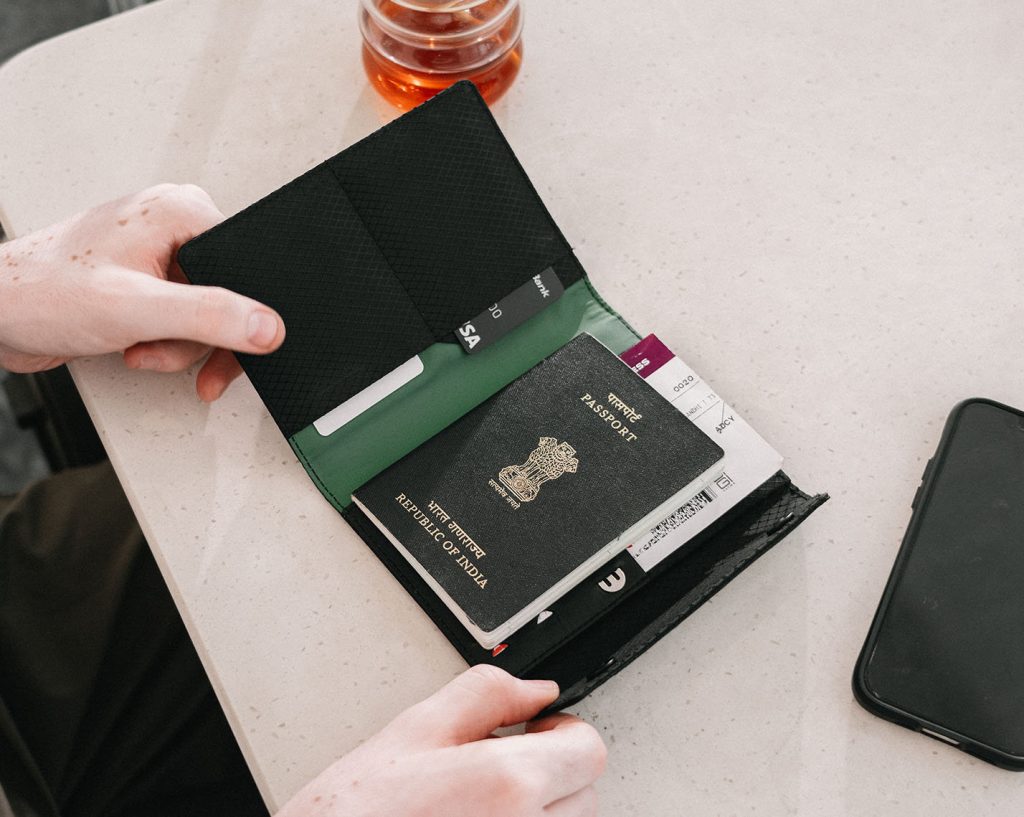 Durable Ripstop travel wallet with slim profile, passport slot, card holders, SIM cutouts, and magnetic flap closure.