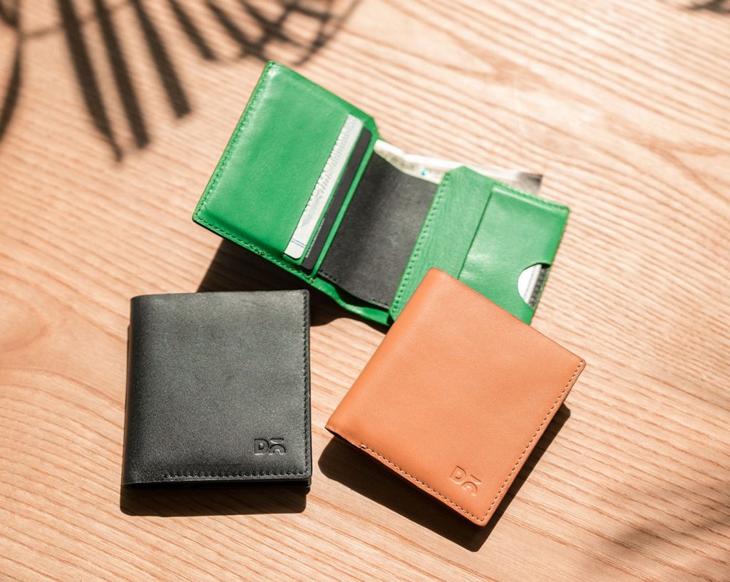 Slim wallet made from full-grain leather with flap pocket for cards and cash, featuring a bi-fold design in dual-tone colorway.
