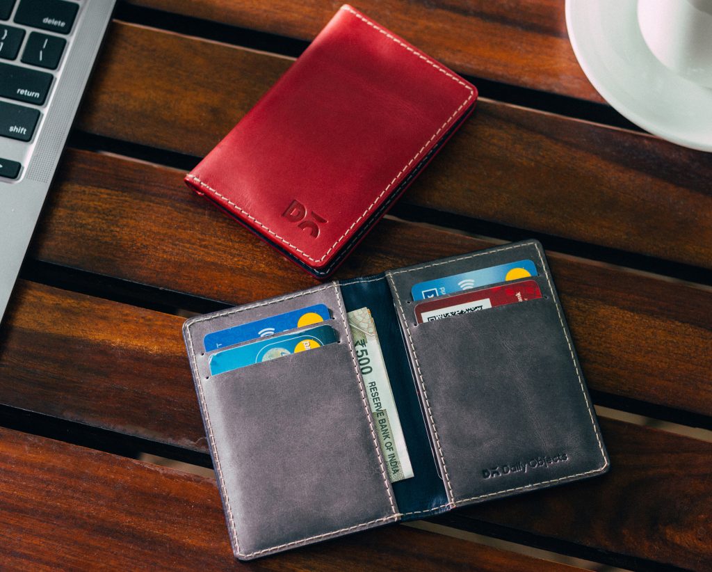 Slim wallet in genuine leather with bi-fold design, compact profile, card slots, and earthy tone combinations.